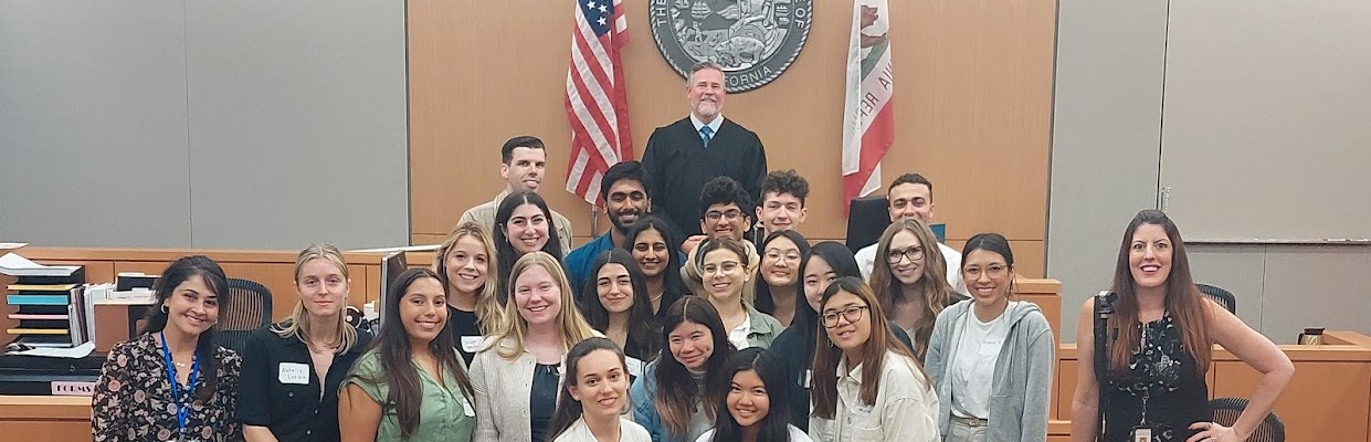 Photo of students and faculty a courtroom